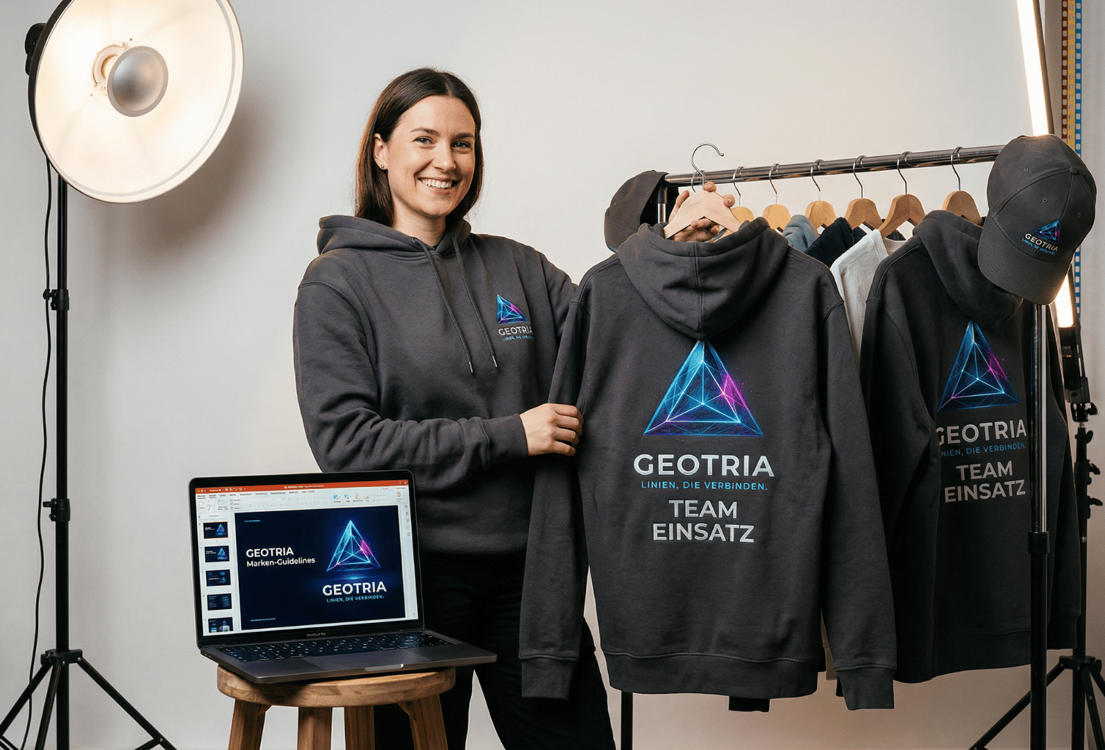 Mitarbeiterin präsentiert Geotria Teamkleidung mit Logo für Employer Branding und Teamidentität
